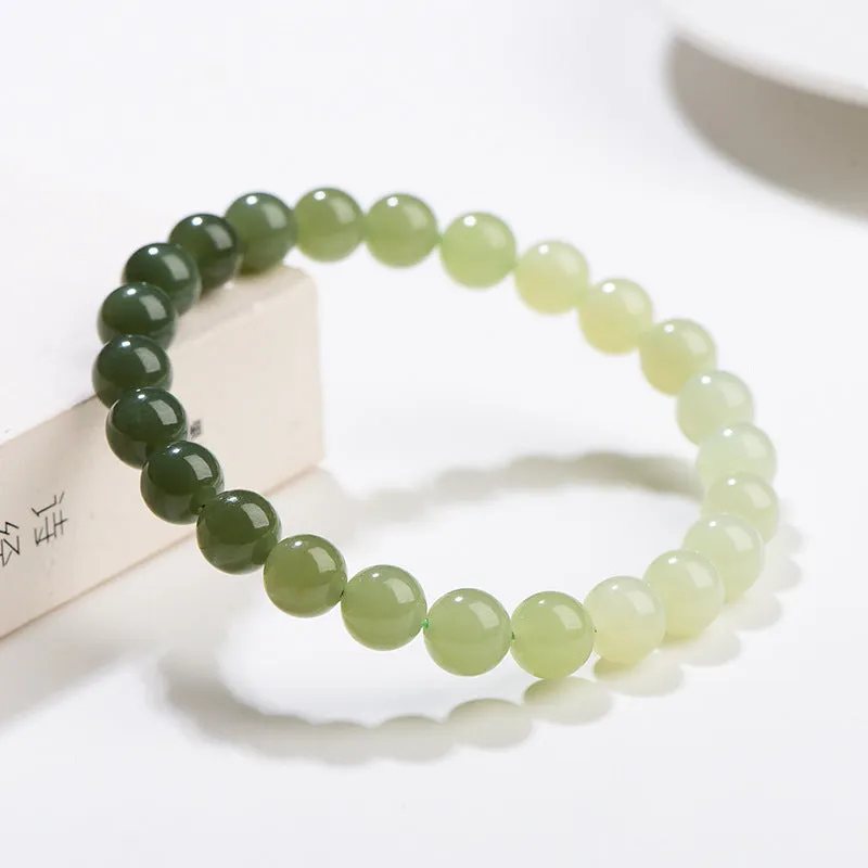 Natural clear water Hetian jade bracelet with round beads and barrel bead options on a wrist.