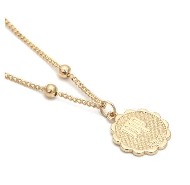 Gold plated metal zodiac constellation pendant necklace with bead chain on white background