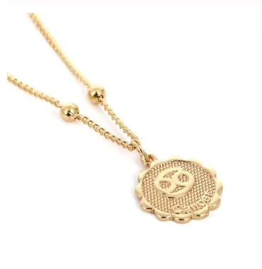 Gold plated metal zodiac constellation pendant necklace with bead chain on white background