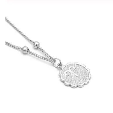 Gold plated metal zodiac constellation pendant necklace with bead chain on white background