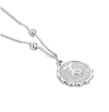 Gold plated metal zodiac constellation pendant necklace with bead chain on white background