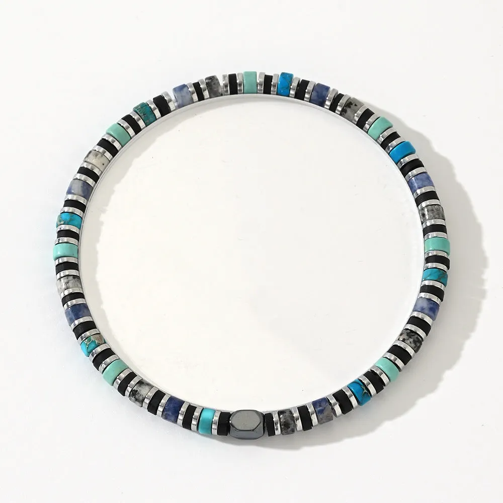 Close-up of a hand-woven cylindrical bohemian bracelet made from natural semi-precious stones in geometric patterns