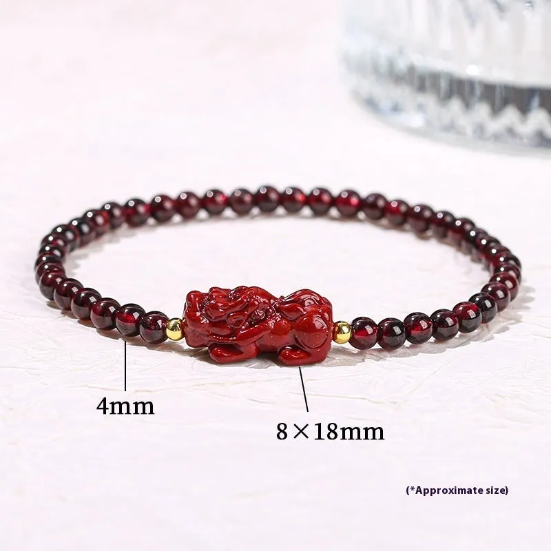 Geometric square garnet bracelet with carved purple pixiu charm on wrist