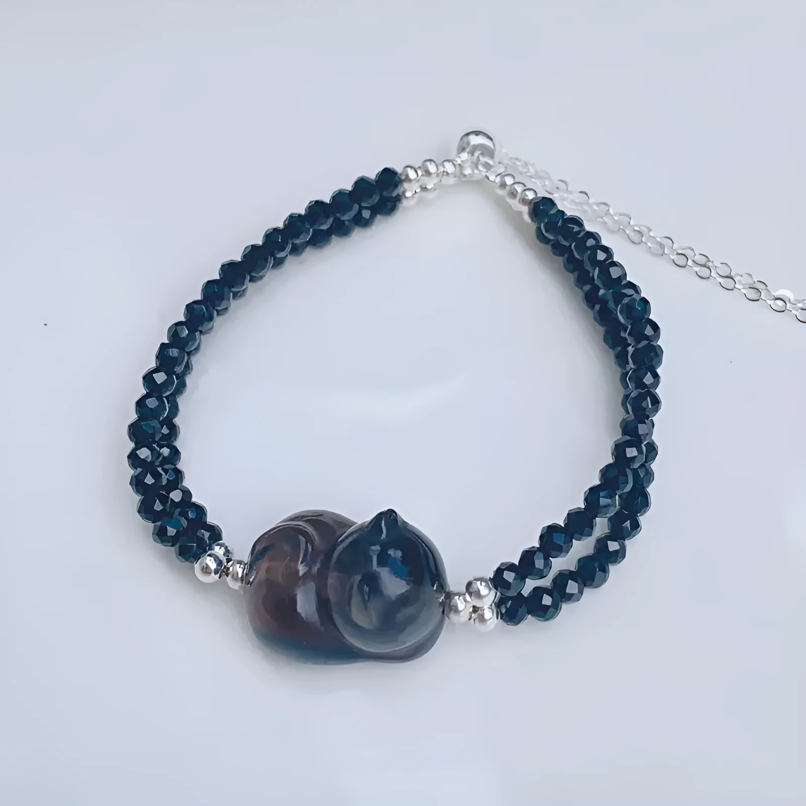 Cold obsidian climbing cat bracelet with hand-carved design and adjustable clasp