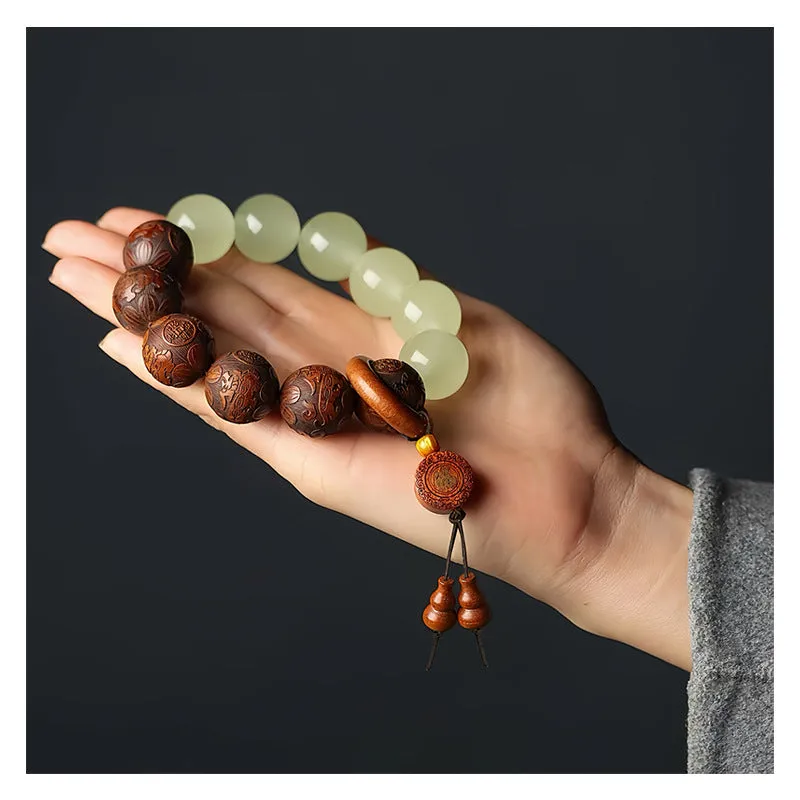 Flexible rosewood bead bracelet with carved Fu character in amass fortunes colour.