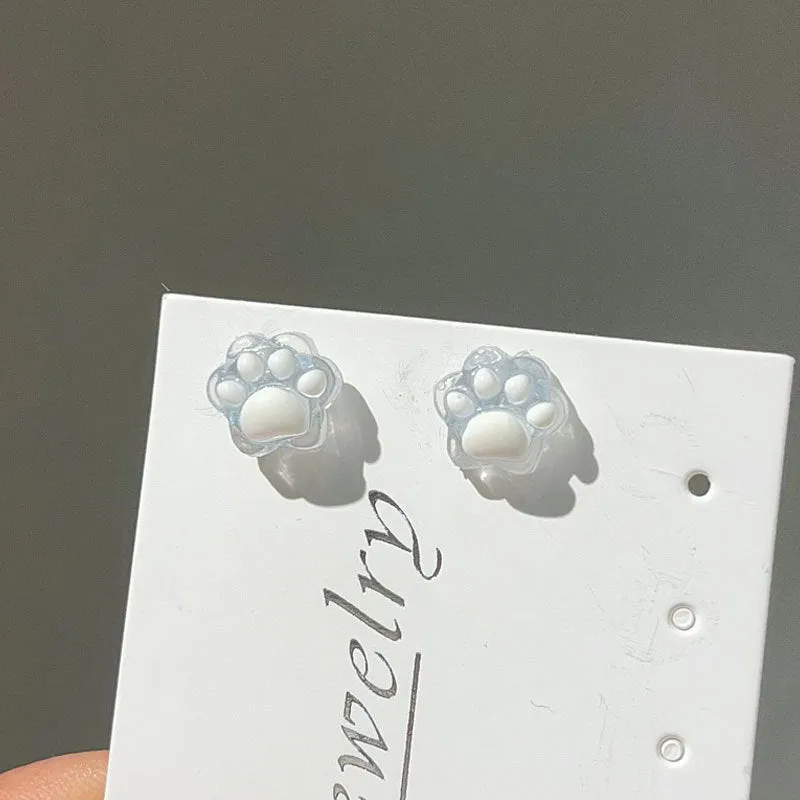 Cat paw magnetic ear clips in transparent pink colour with plastic resin finish, packaged as one pair
