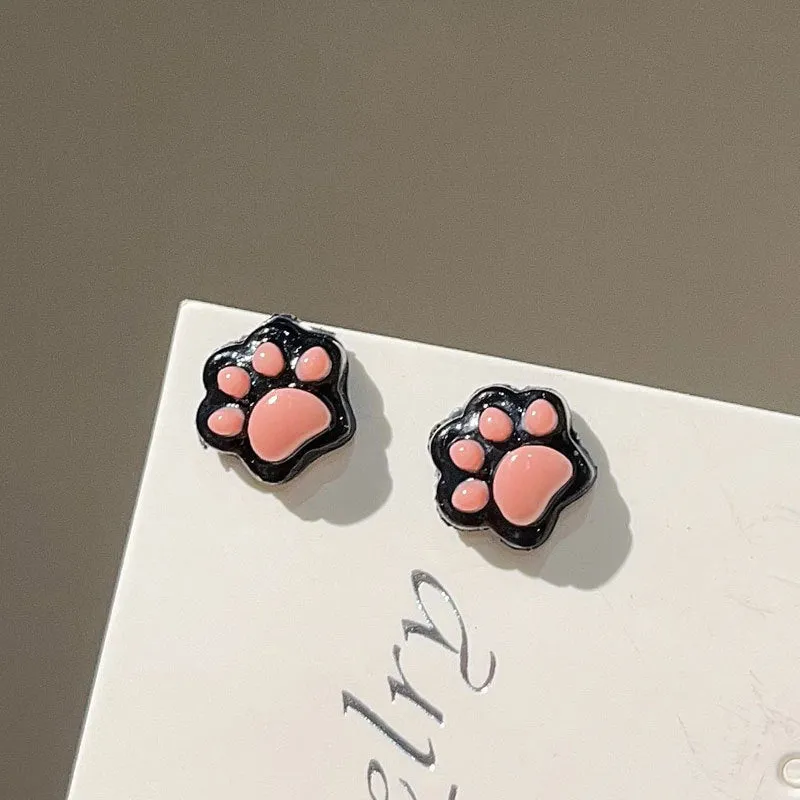 Cat paw magnetic ear clips in transparent pink colour with plastic resin finish, packaged as one pair