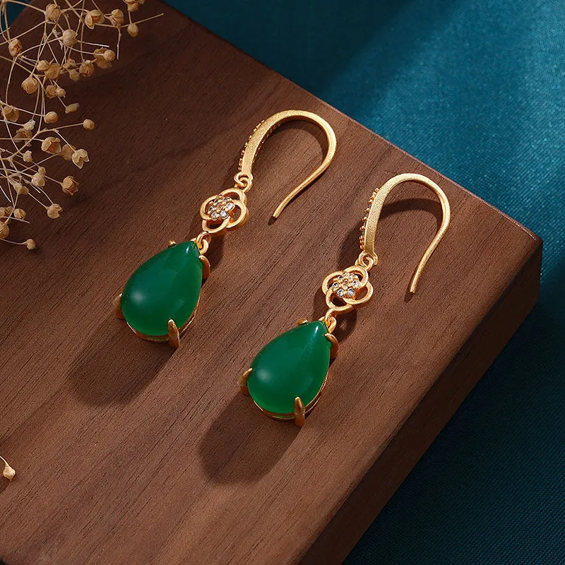 Gold-plated drop agate earrings on display showing alloy base and stone pendant