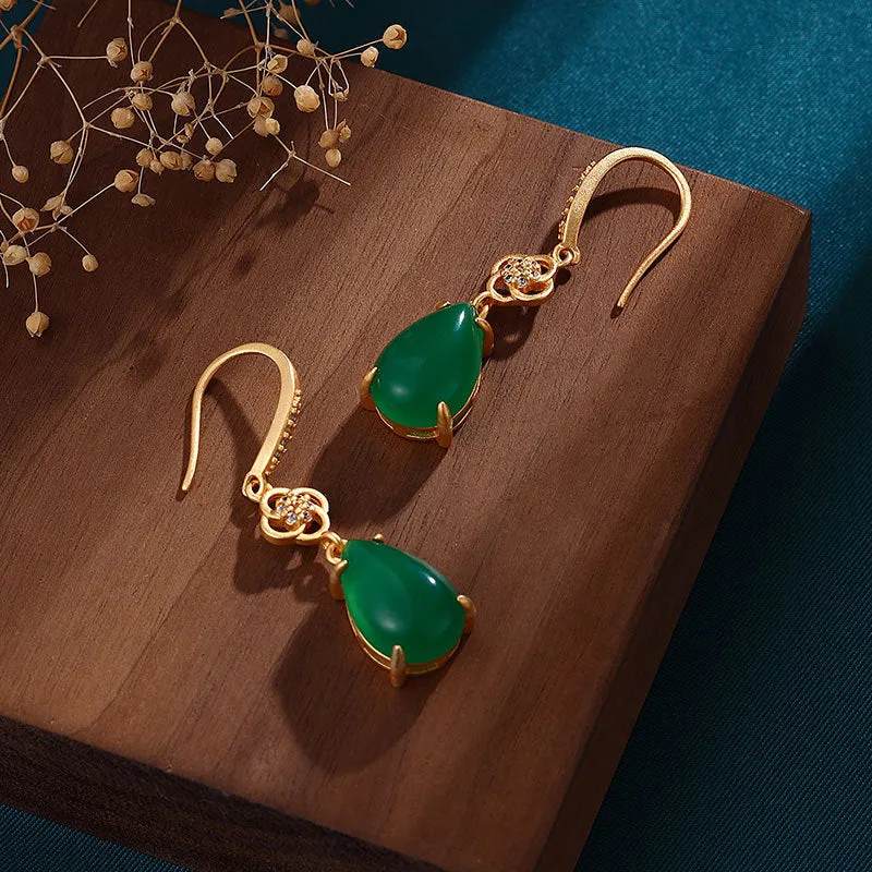 Gold-plated drop agate earrings on display showing alloy base and stone pendant
