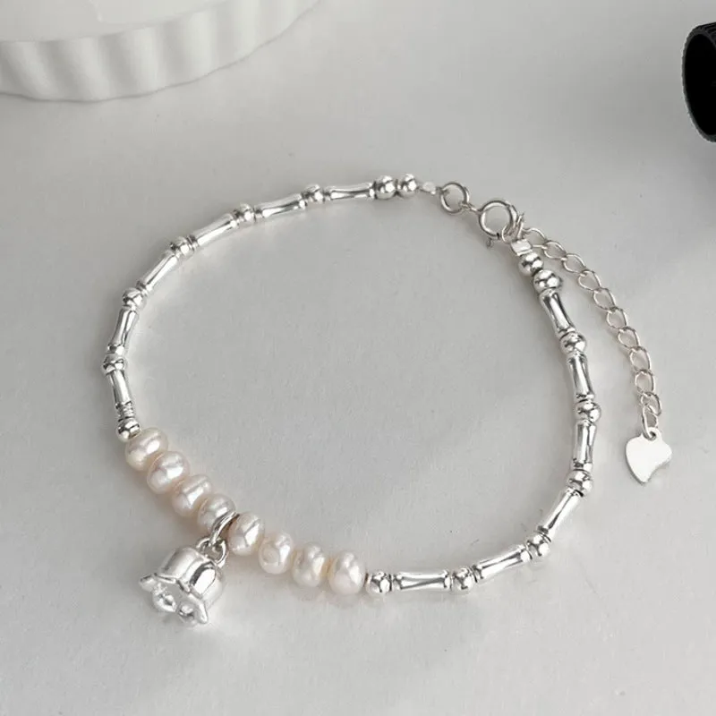 Silver pearl Lily of the Valley pendant bracelet on display