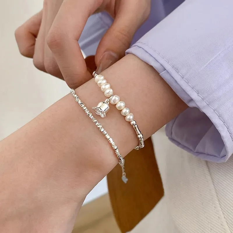 Silver pearl Lily of the Valley pendant bracelet on display