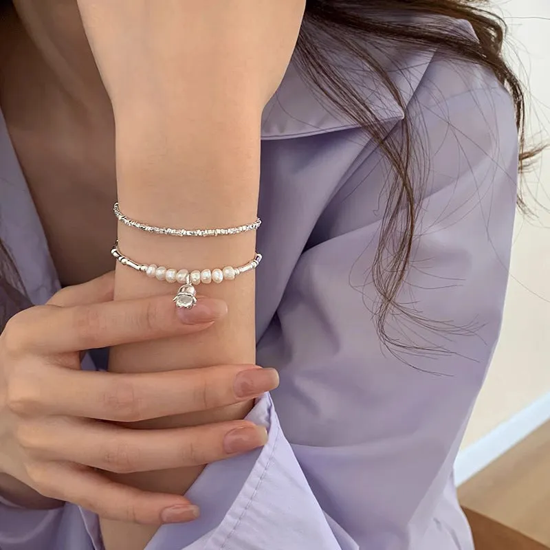 Silver pearl Lily of the Valley pendant bracelet on display