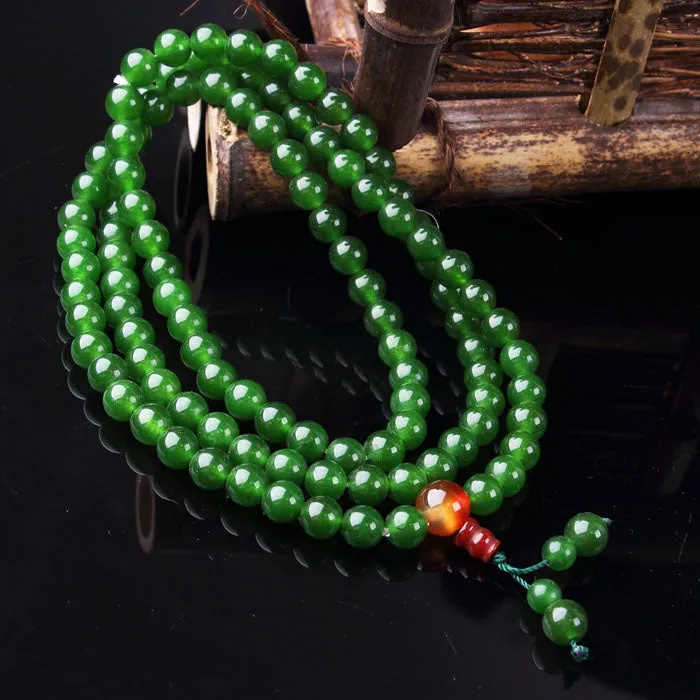 Green spinach jade quartz rock rosary bracelet with Buddha head charm on wrist