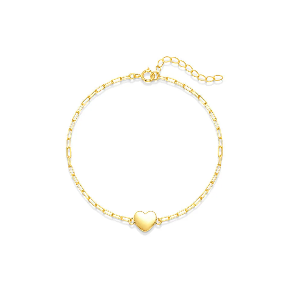 Close-up of a women's sterling silver bracelet with a glossy heart charm on an adjustable clip chain.