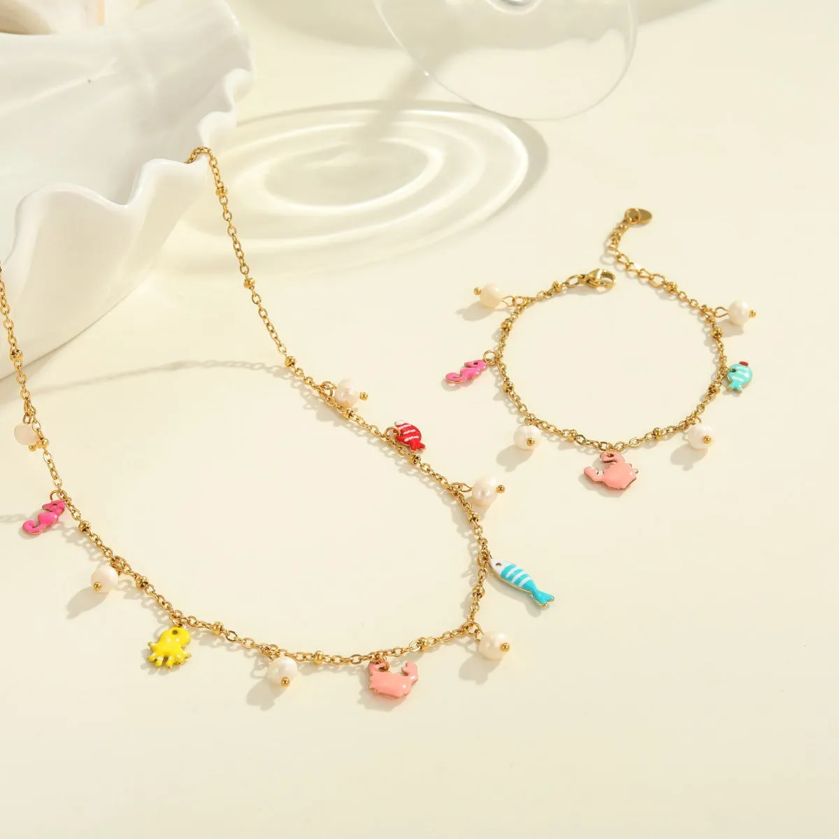 Stainless steel pendant necklace with geometric shape and 18K gold electroplating, paired with a titanium steel bracelet, for women