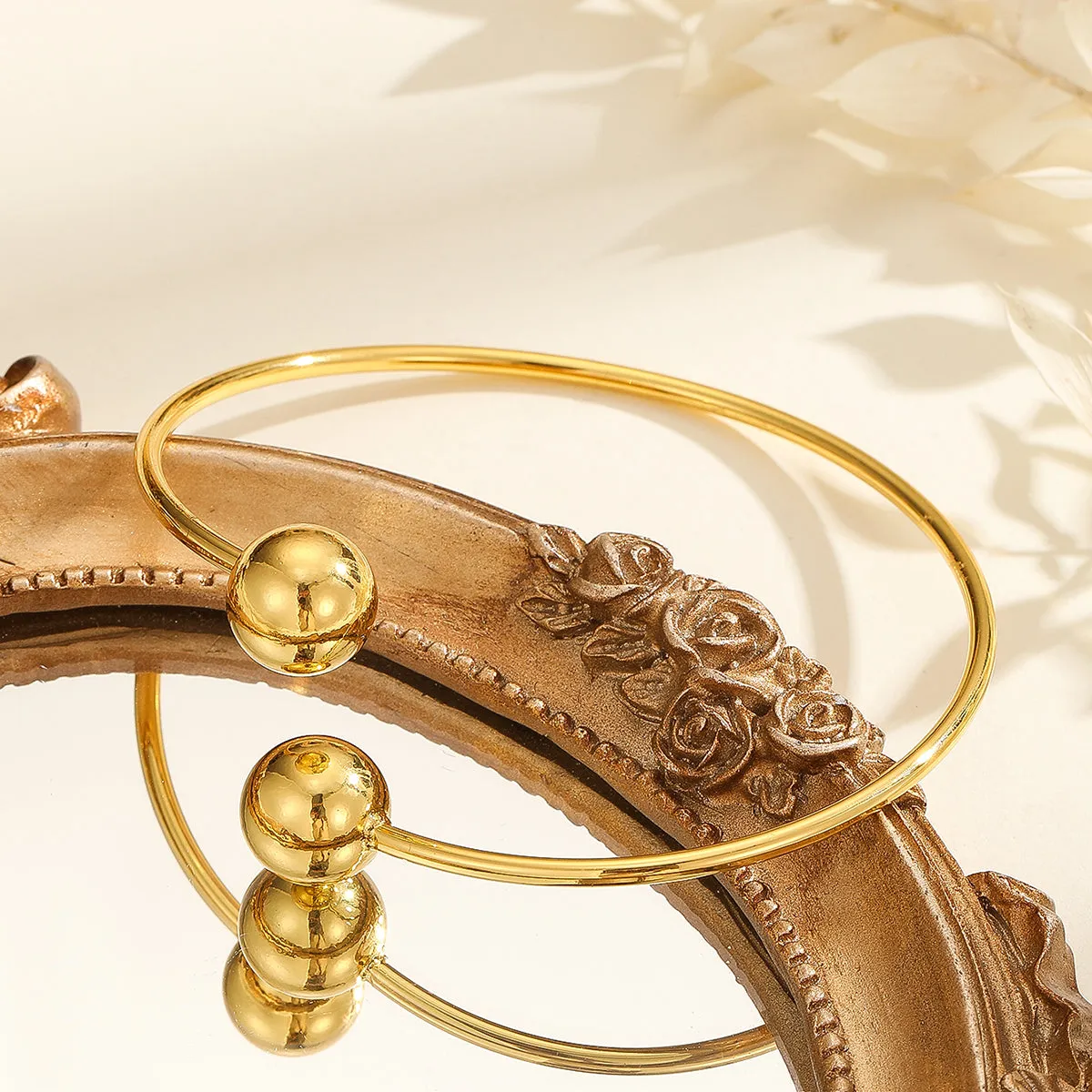 Golden copper plated 18k gold double bead opening bracelet on white background