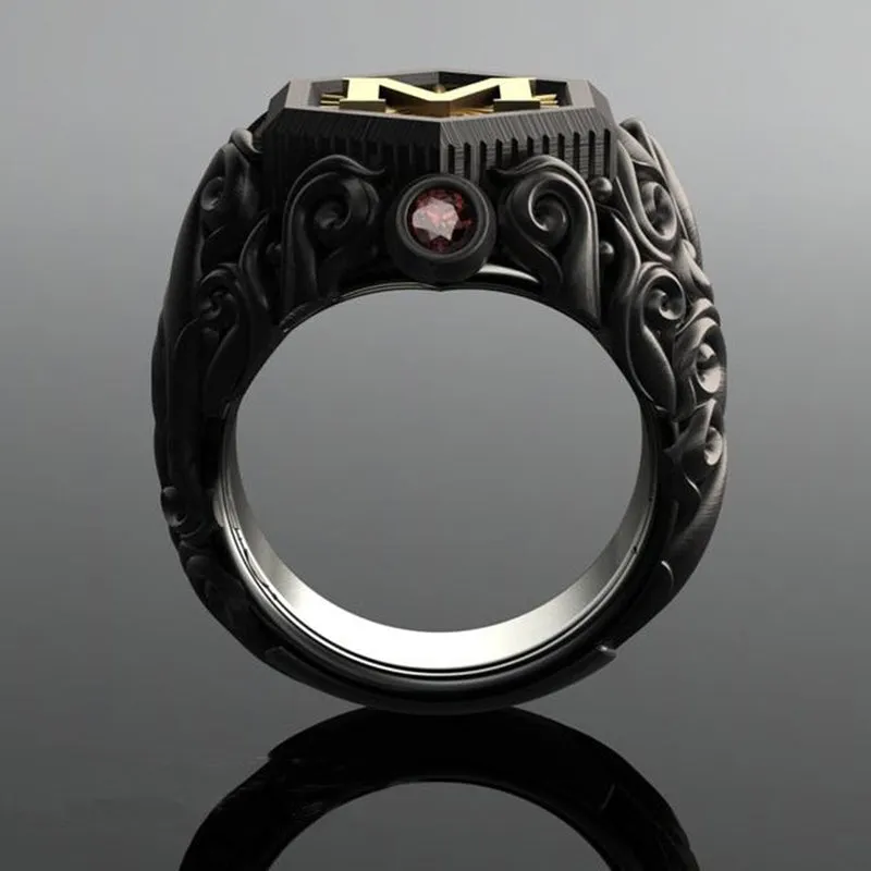 Black alloy decorative ring with carved leaf design on white background