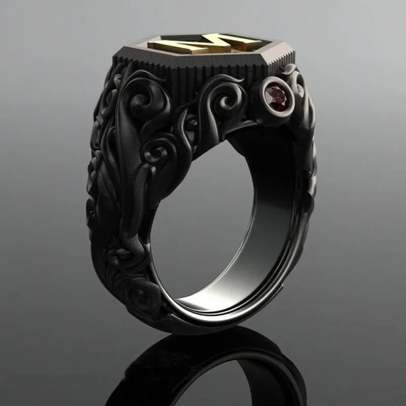 Black alloy decorative ring with carved leaf design on white background