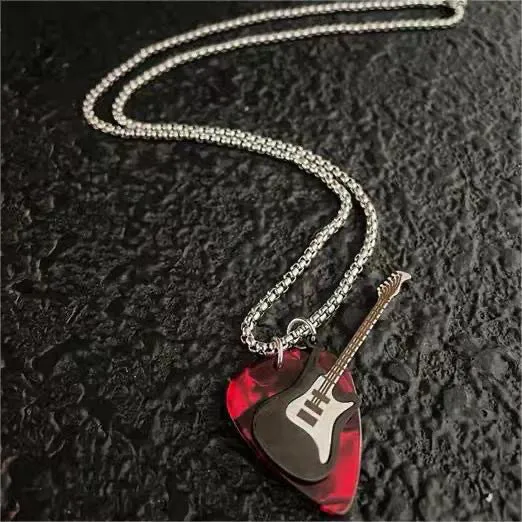 Black guitar pendant necklace in titanium steel on box chain, lithographic finish, women's punk rock style accessory.