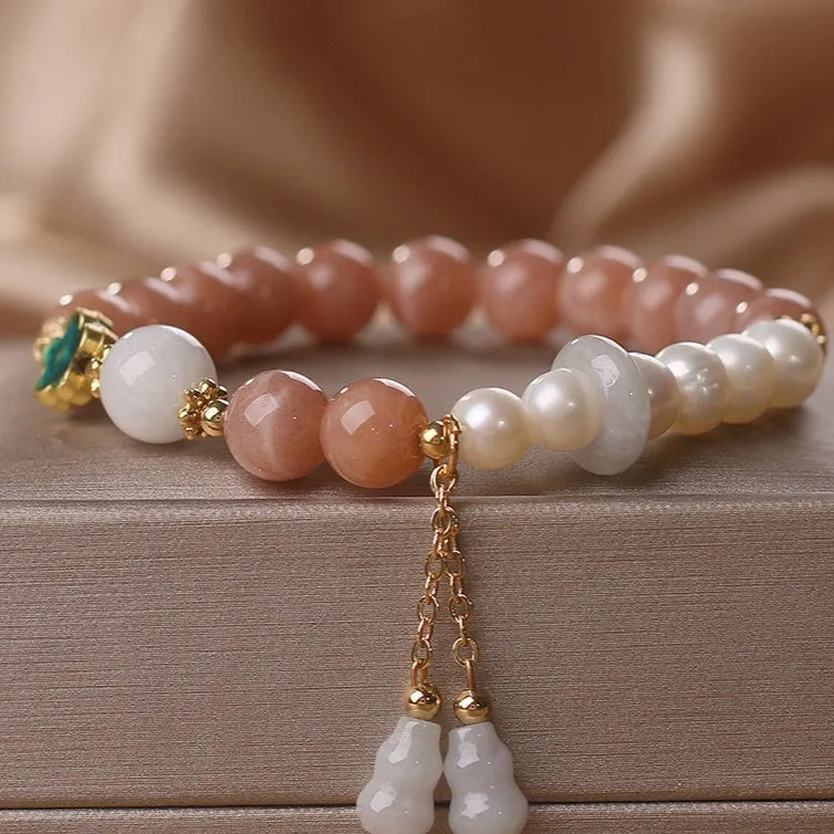 Natural sunstone bracelet with orange sunstone jade calabash pendant and moonstone beads on display