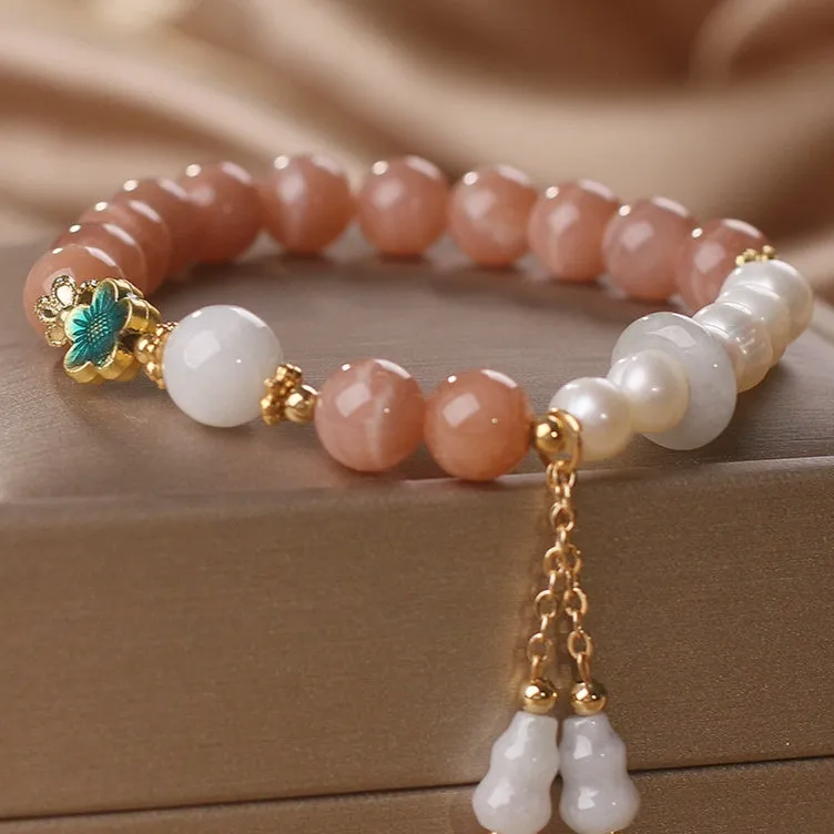 Natural sunstone bracelet with orange sunstone jade calabash pendant and moonstone beads on display
