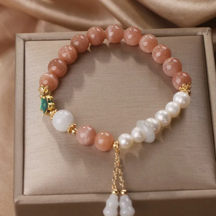 Natural sunstone bracelet with orange sunstone jade calabash pendant and moonstone beads on display