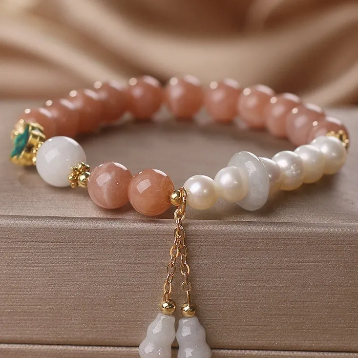 Natural sunstone bracelet with orange sunstone jade calabash pendant and moonstone beads on display