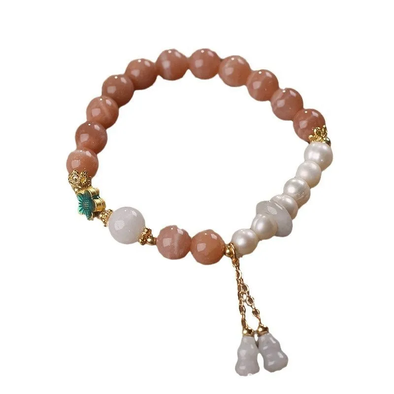 Natural sunstone bracelet with orange sunstone jade calabash pendant and moonstone beads on display