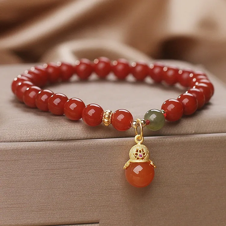 Natural red agate bracelet with zodiac pendant on wrist