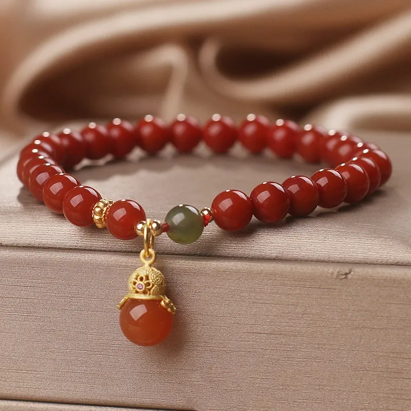 Natural red agate bracelet with zodiac pendant on wrist