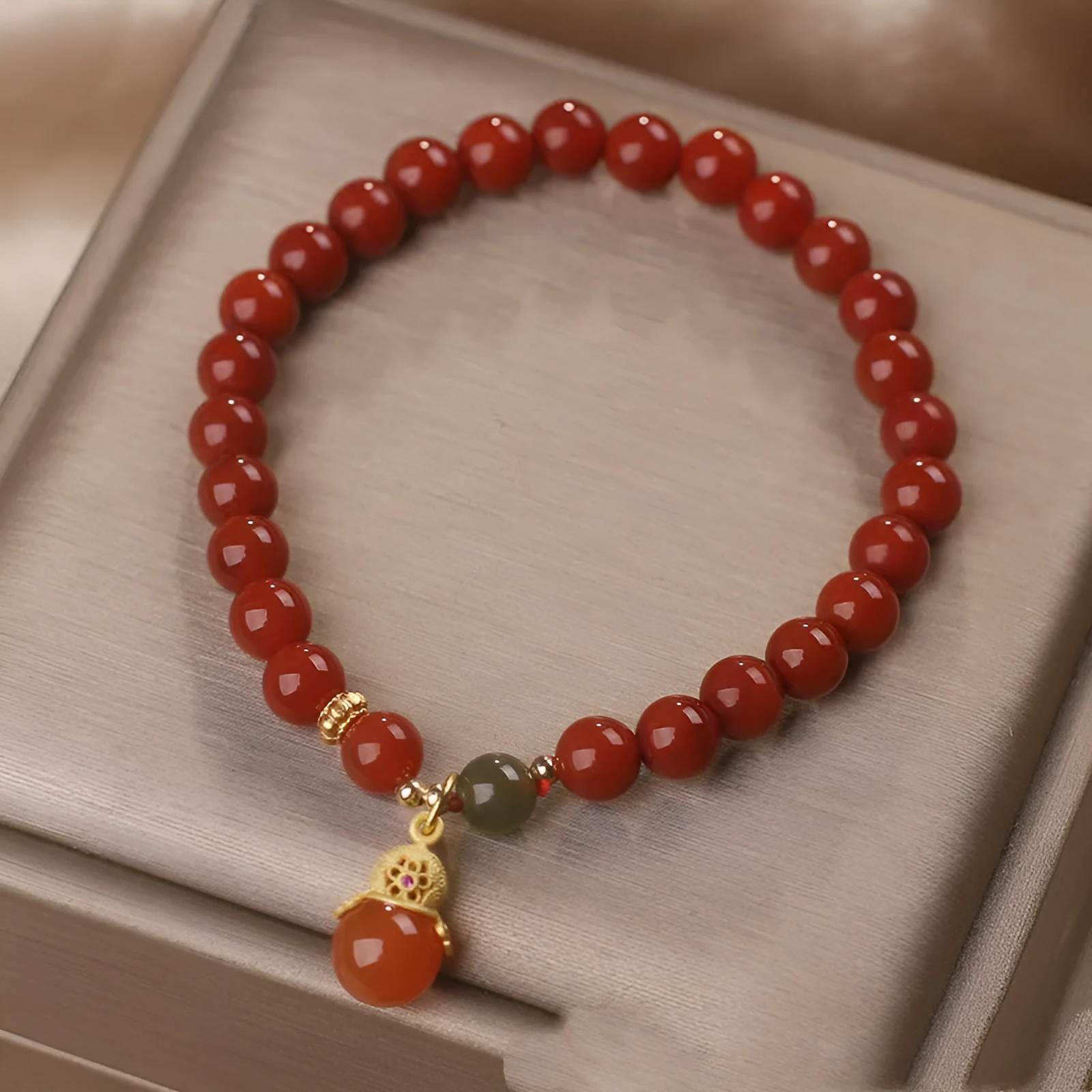Natural red agate bracelet with zodiac pendant on wrist
