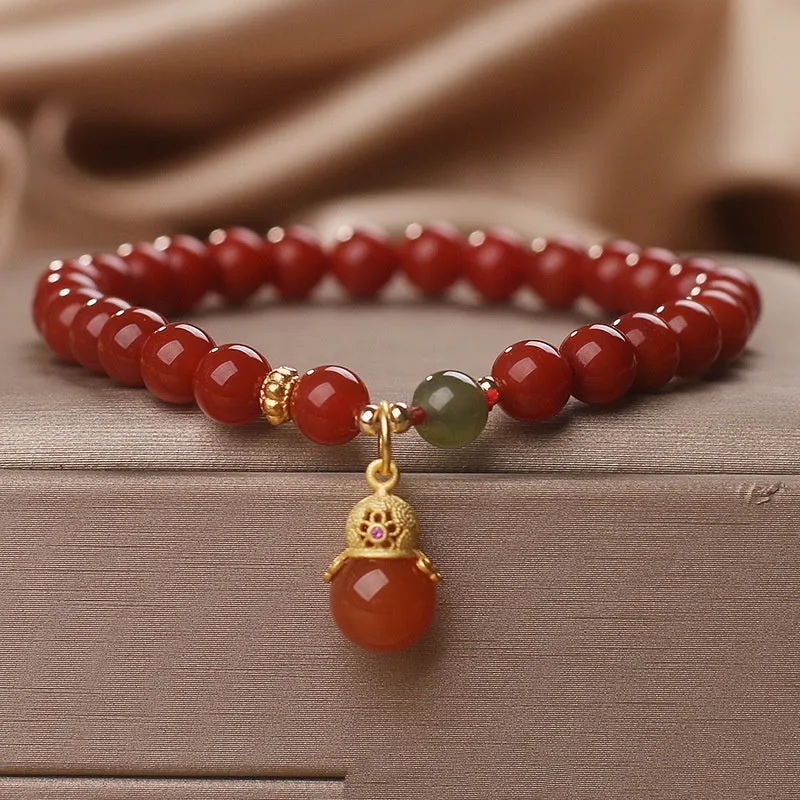 Natural red agate bracelet with zodiac pendant on wrist