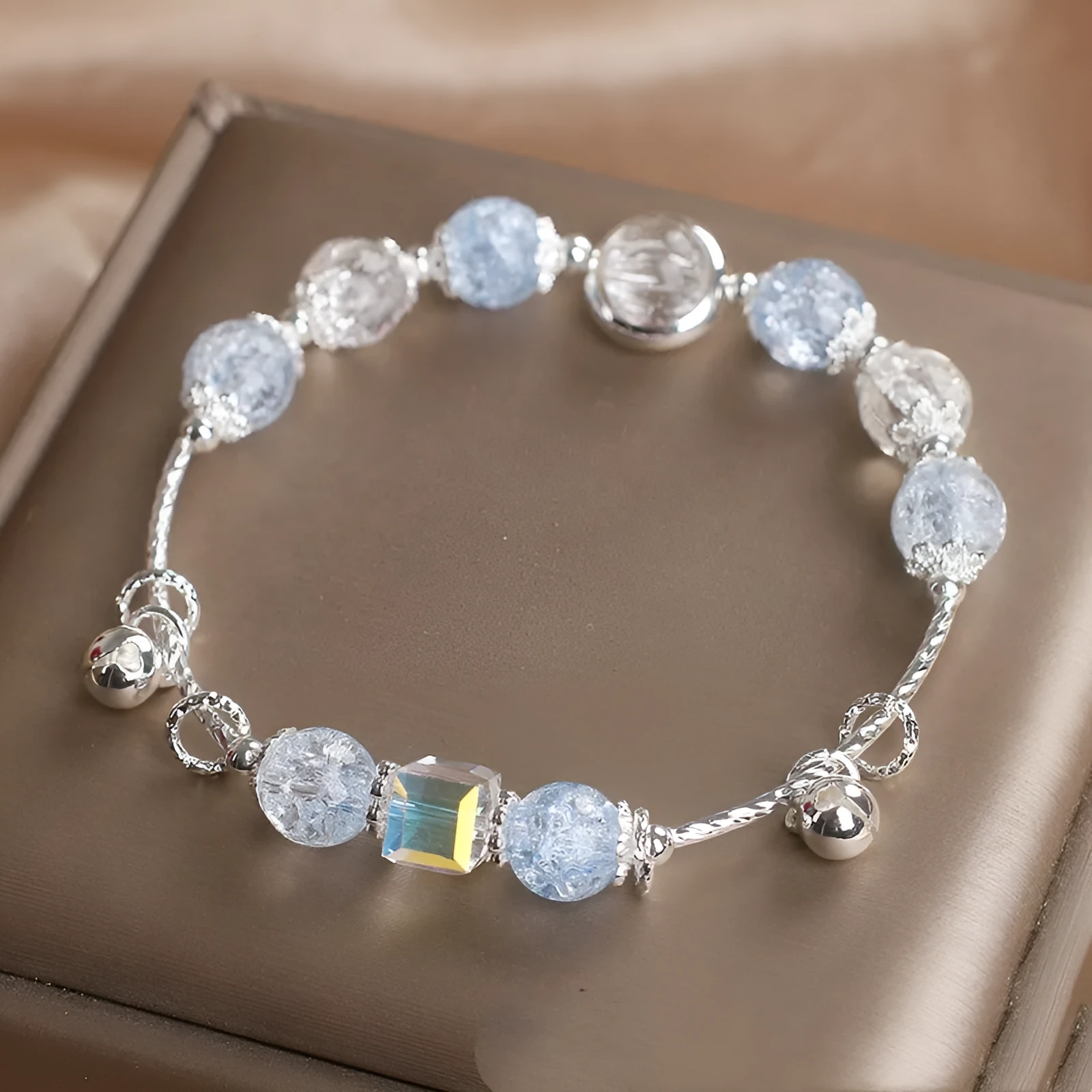 Light blue artificial crystal bell bracelet on woman's wrist