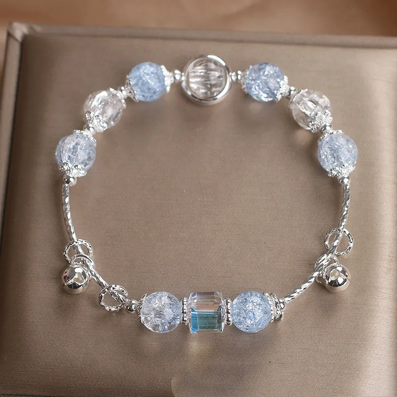 Light blue artificial crystal bell bracelet on woman's wrist