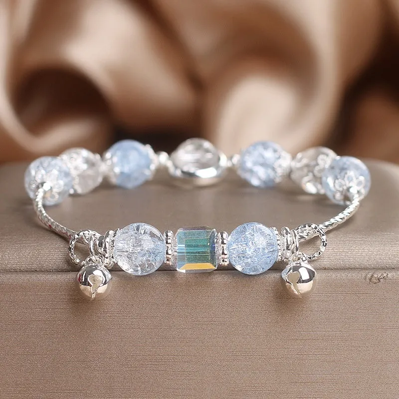 Light blue artificial crystal bell bracelet on woman's wrist