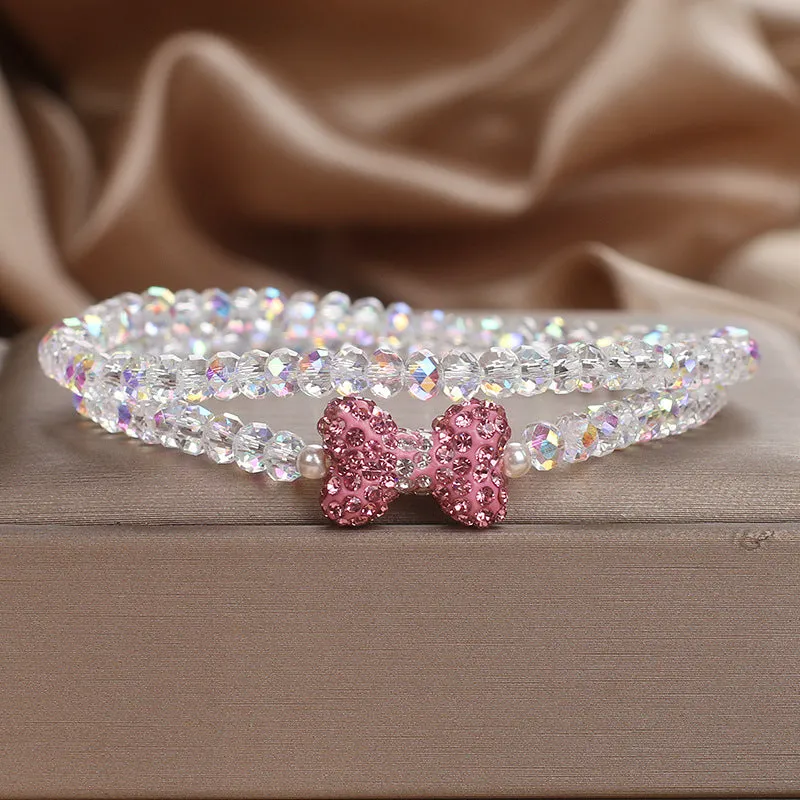 Double ring crystal bracelet with pearl and rhinestone accents on light background
