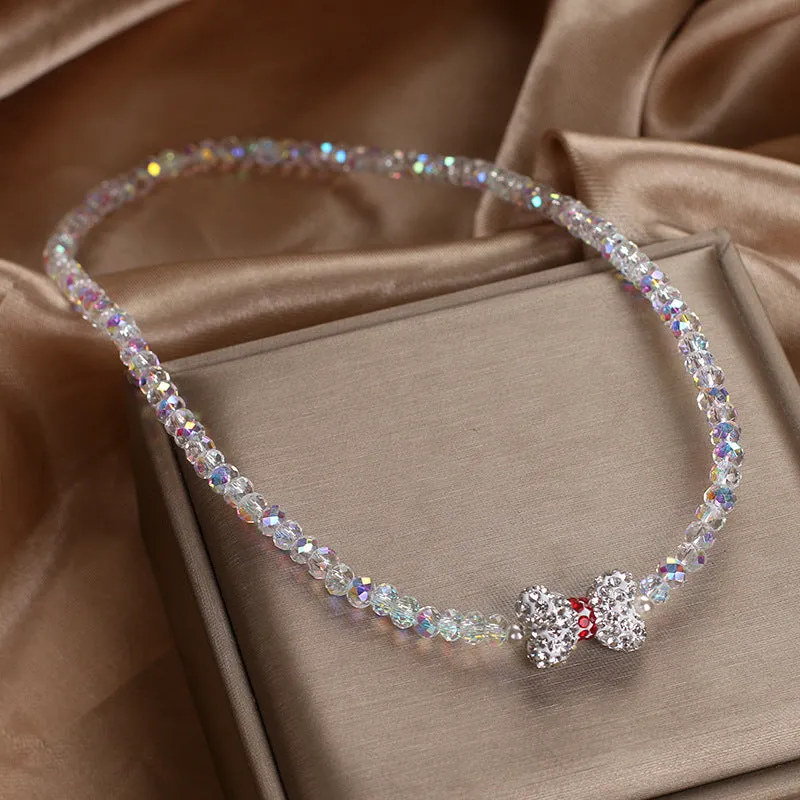 Double ring crystal bracelet with pearl and rhinestone accents on light background