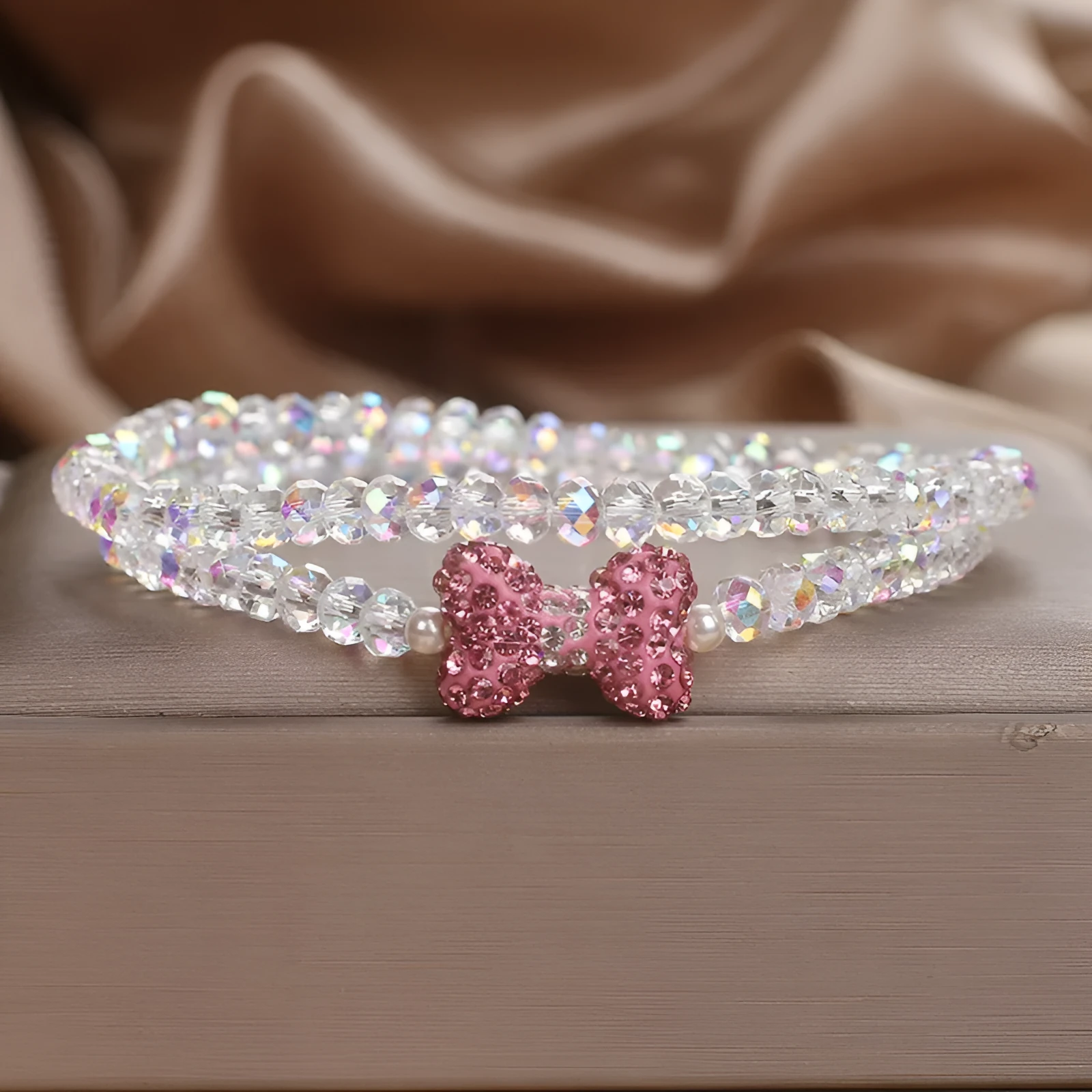 Double ring crystal bracelet with pearl and rhinestone accents on light background