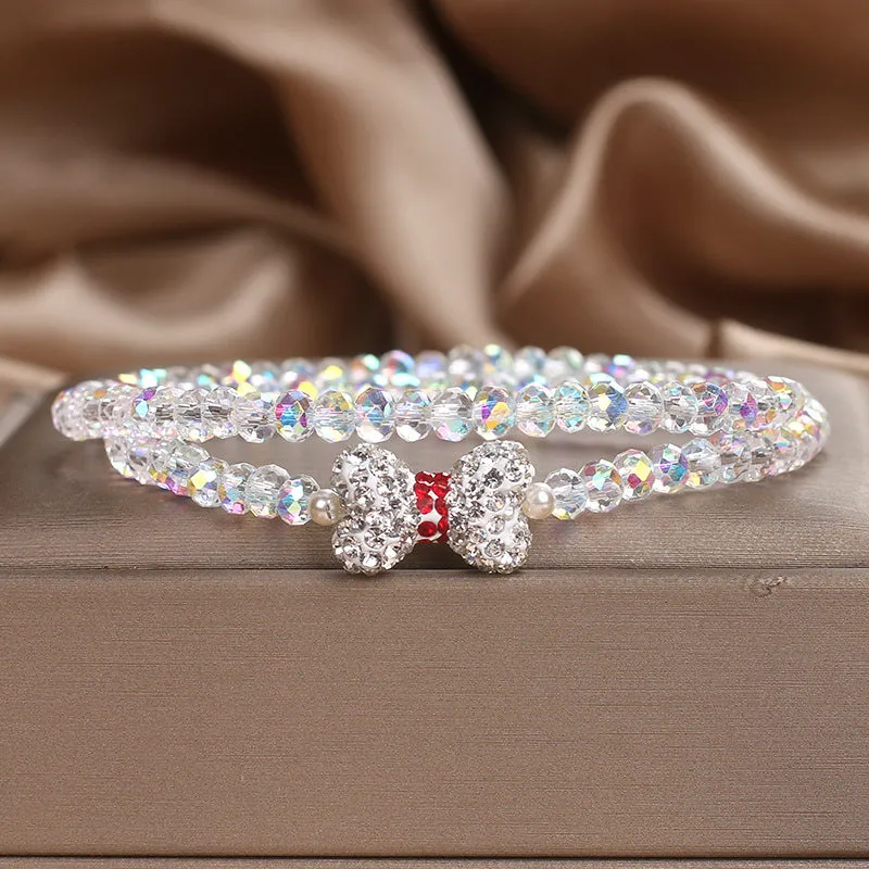 Double ring crystal bracelet with pearl and rhinestone accents on light background