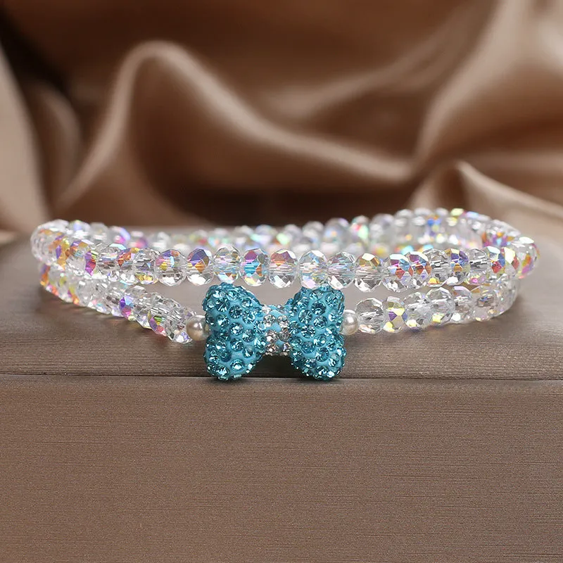 Double ring crystal bracelet with pearl and rhinestone accents on light background