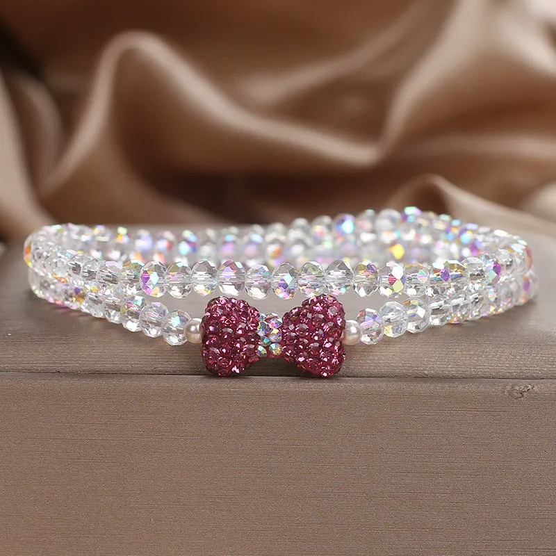 Double ring crystal bracelet with pearl and rhinestone accents on light background