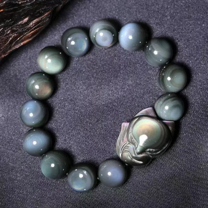 Obsidian stone bracelet with carved fox design in cartoon style, shown in different diameter sizes.