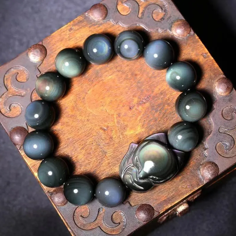 Obsidian stone bracelet with carved fox design in cartoon style, shown in different diameter sizes.
