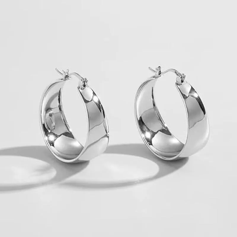 Widened curved stainless steel earrings in gold and steel colours showing 25mm and 30mm size options