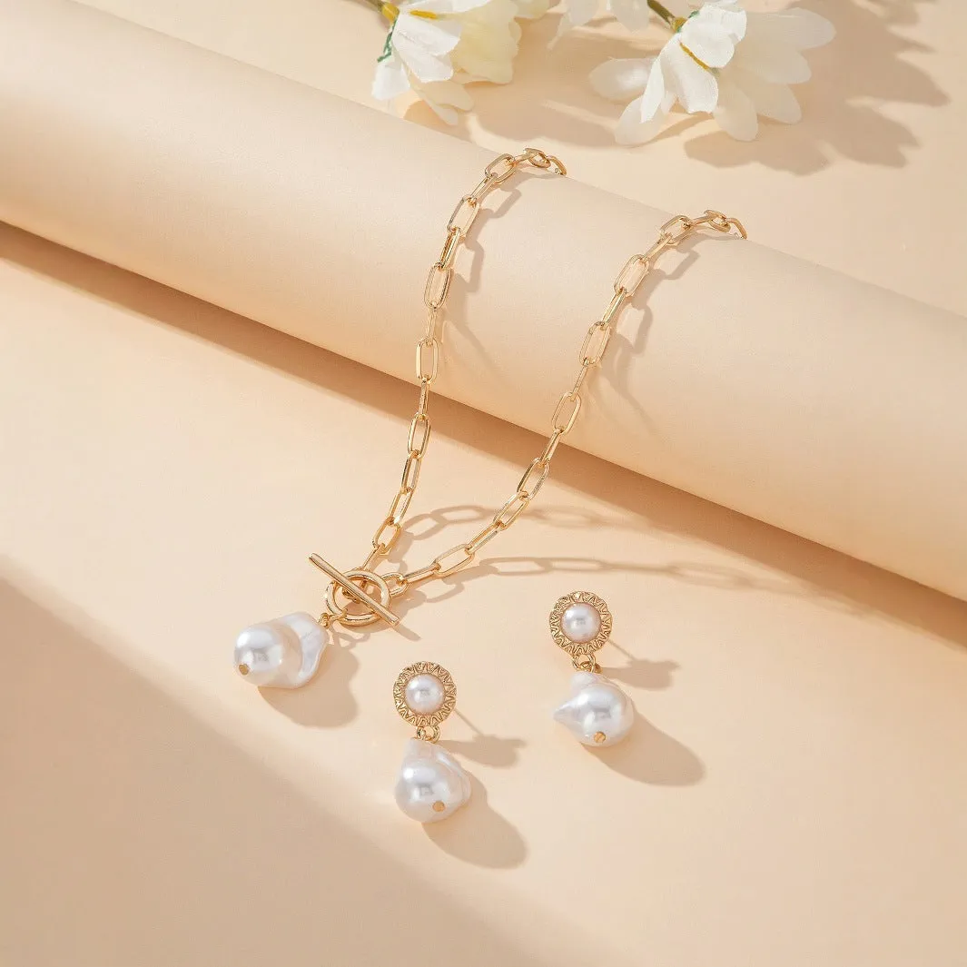 Gold-tone retro baroque necklace and earring set with a pearl pendant on an iron chain.