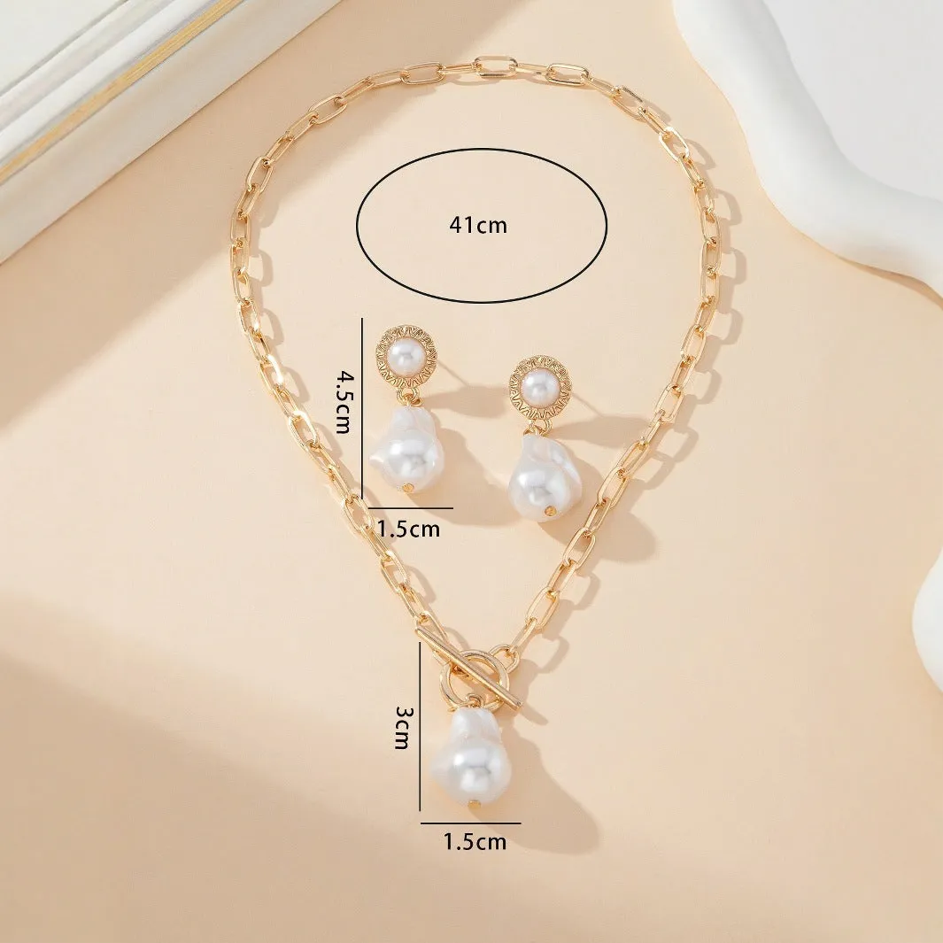 Gold-tone retro baroque necklace and earring set with a pearl pendant on an iron chain.