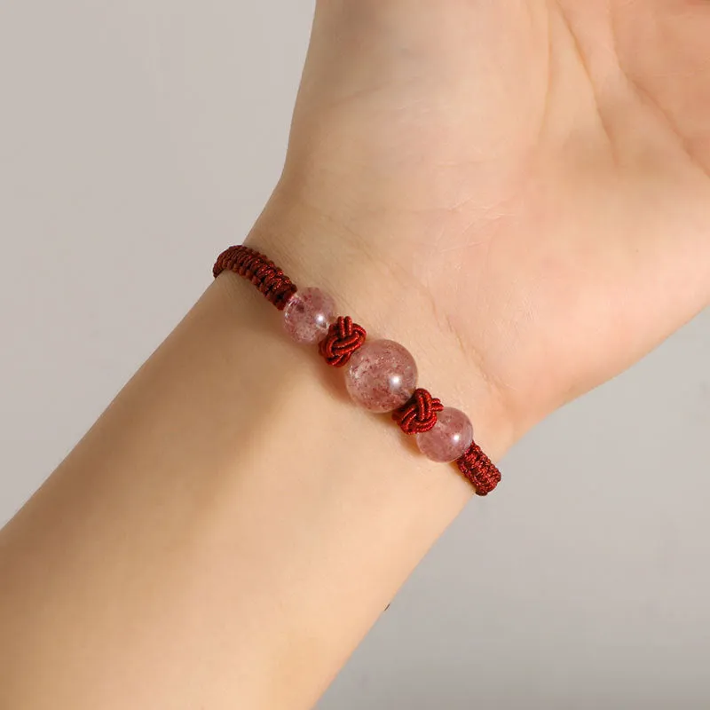 Woven red rope bracelet with spherical strawberry quartz beads and alloy clasp