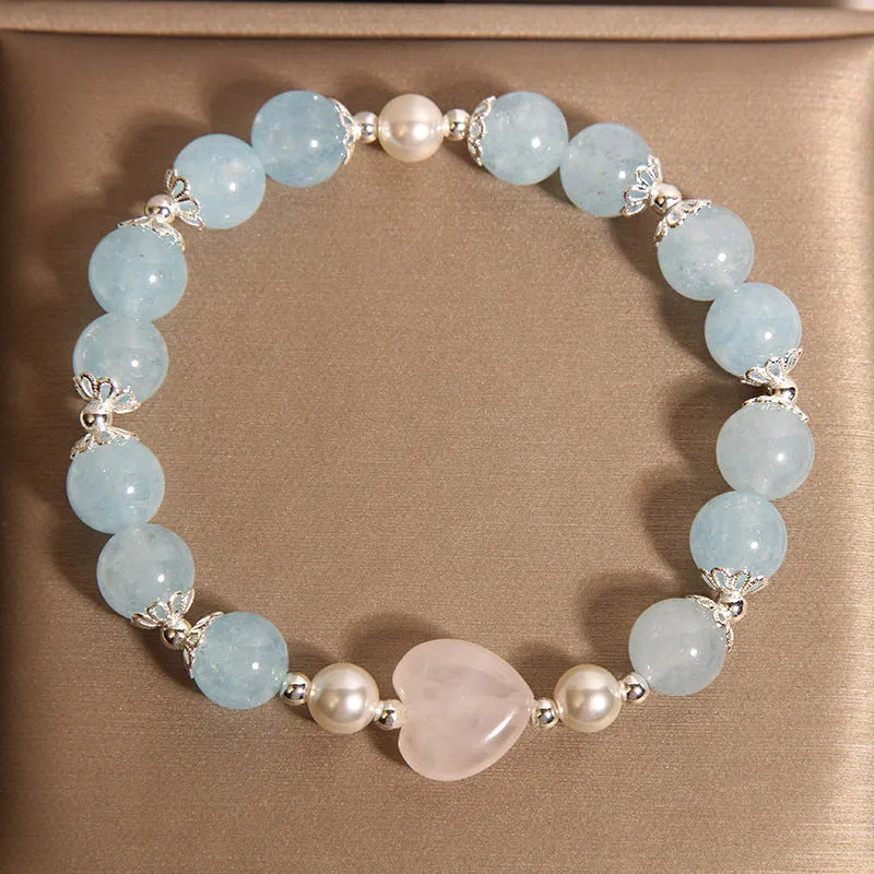 Natural aquamarine crystal bracelet with three shell pearls and lobster clasp on display