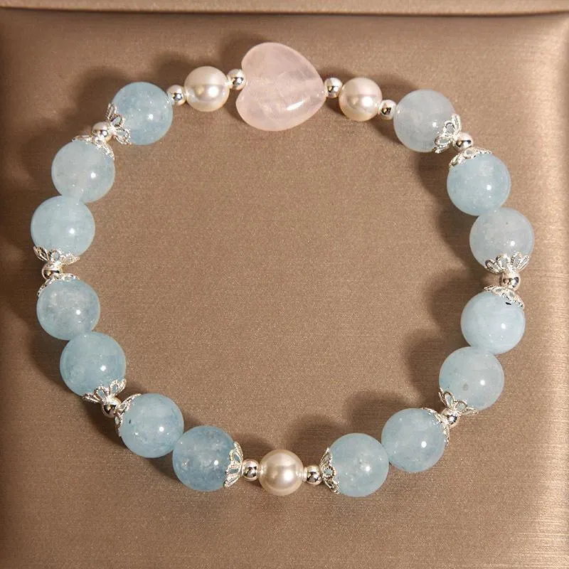 Natural aquamarine crystal bracelet with three shell pearls and lobster clasp on display