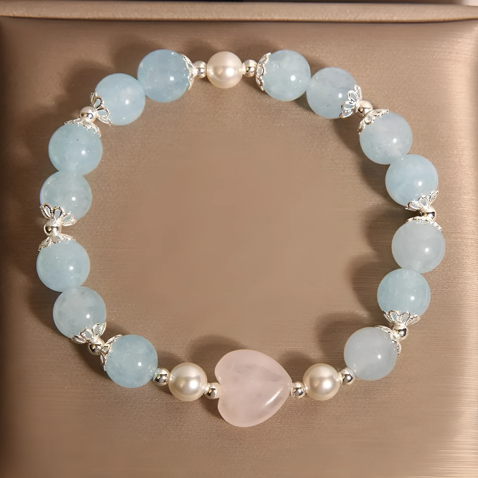 Natural aquamarine crystal bracelet with three shell pearls and lobster clasp on display